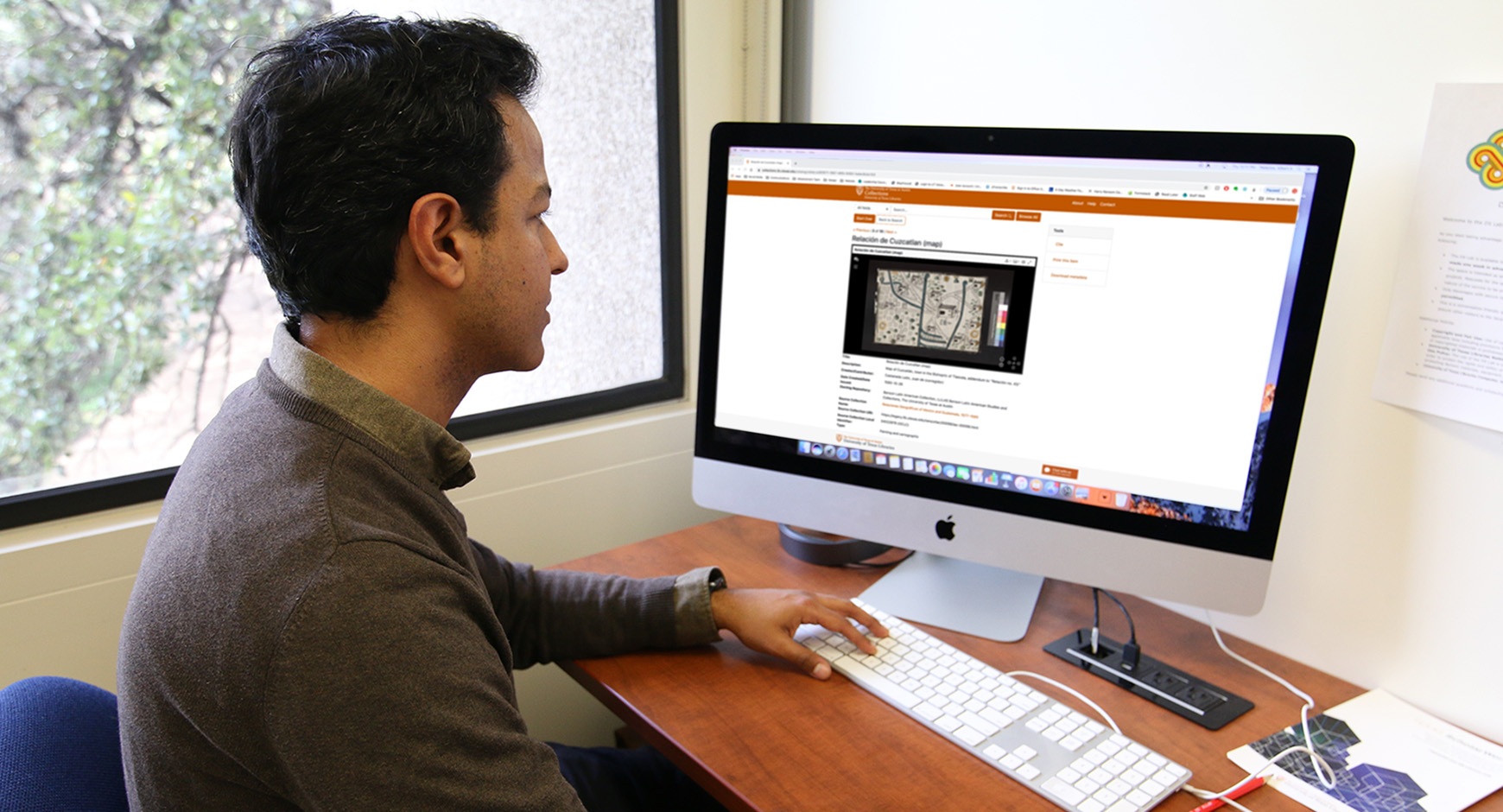 Person at a desk looking at a computer