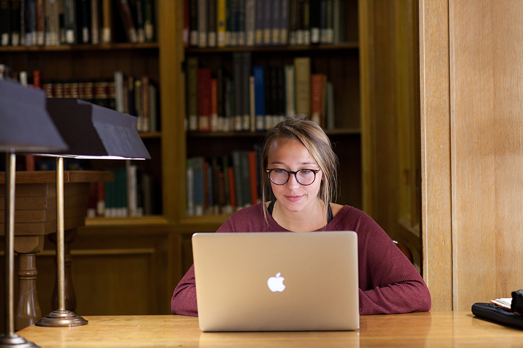 Person at a desk looking at a computer