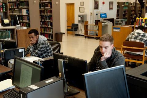 Students in front of a row of computers