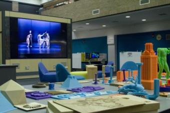 The image is view of the Video Wall from a Foundry maker station. In the foreground are different projects.