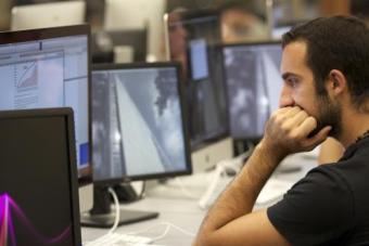 Person in computer lab in front of a monitor