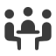 an icon of three people sitting at a table facing each other