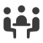 an icon of three people sitting at a table facing each other